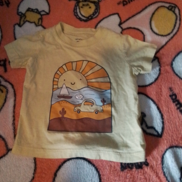 A short sleeve shirt with a sun,water,boat and car on it. - Picture 1 of 2